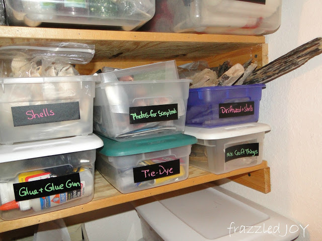 craft supplies organized in plastic tubs