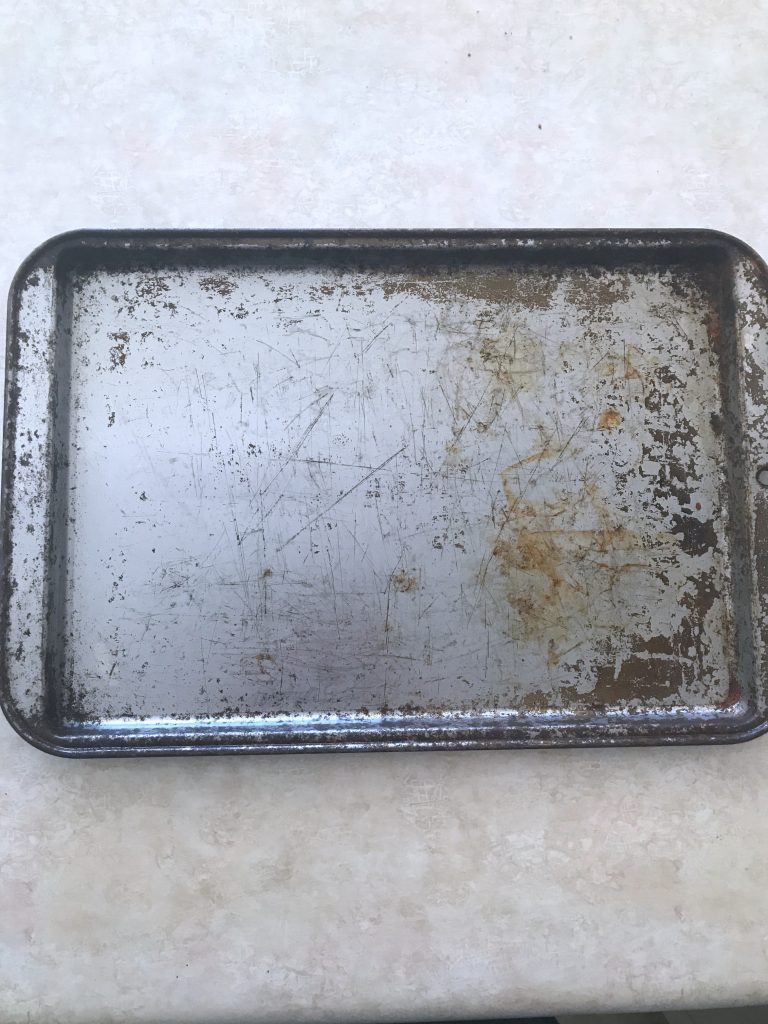 cleaning an old baking sheet
