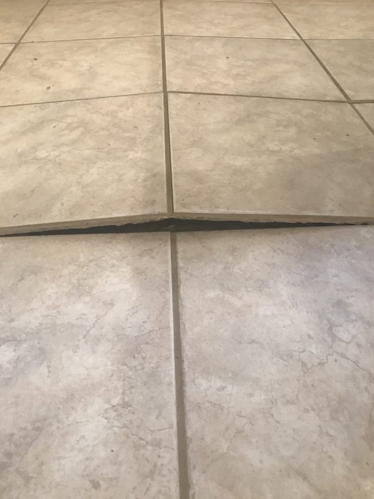 Buckled tile floor