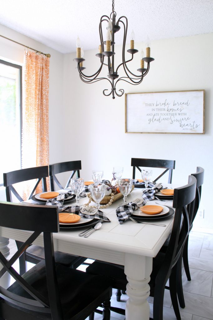 Fall tablescape with orange pumpkins and black and white gingham