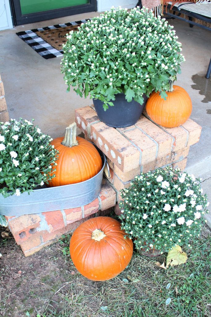 White mums and orange pumpkins front porch fall decor