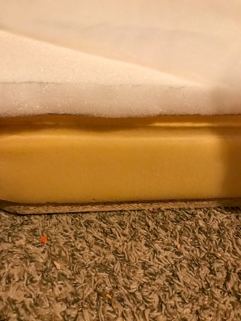 Layers of reupholstering an ottoman