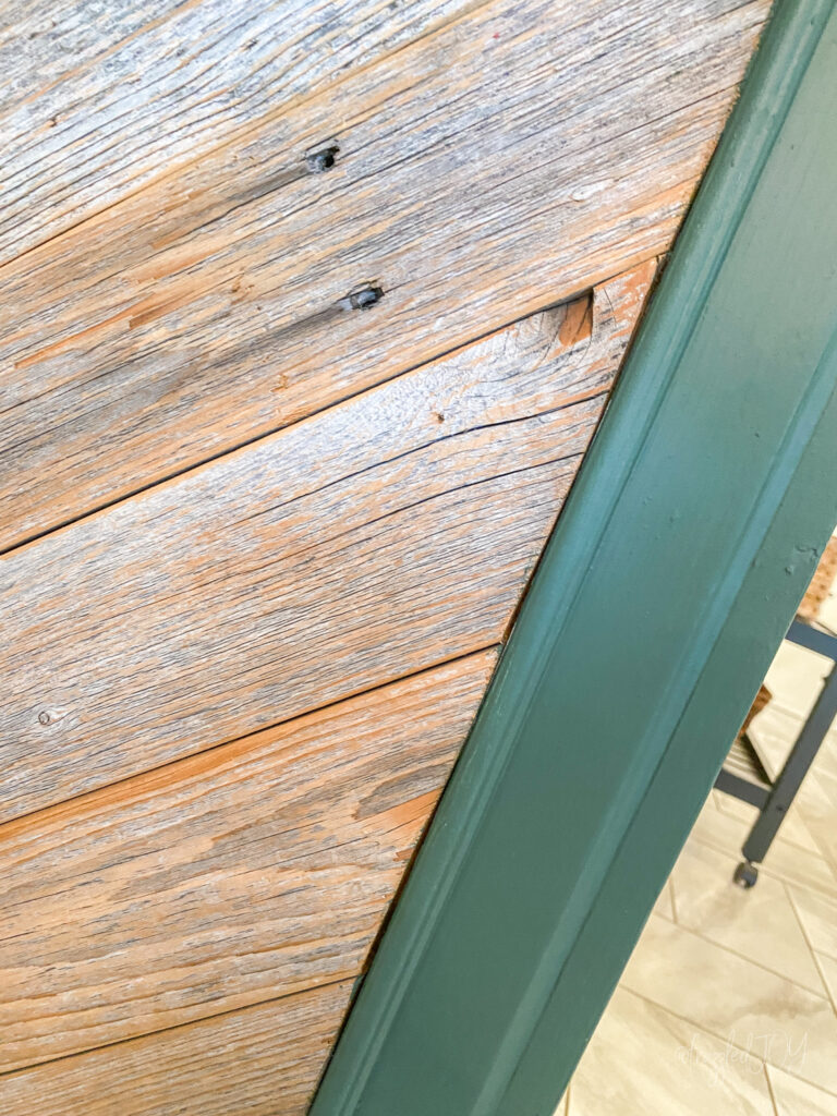 green cabinet with rustic wood island