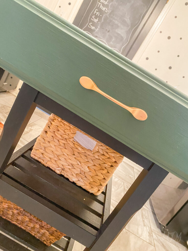 green drawer with gold hardware